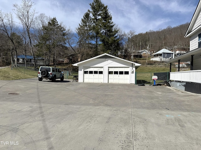 detached garage featuring fence