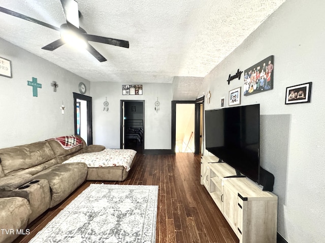 living area featuring a textured ceiling, ceiling fan, and wood finished floors