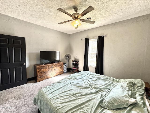 carpeted bedroom featuring visible vents, a textured ceiling, baseboards, ceiling fan, and a textured wall