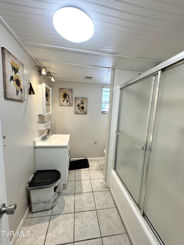 bathroom with tile patterned floors, baseboards, toilet, and vanity