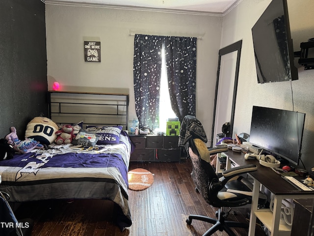 bedroom with crown molding and hardwood / wood-style flooring