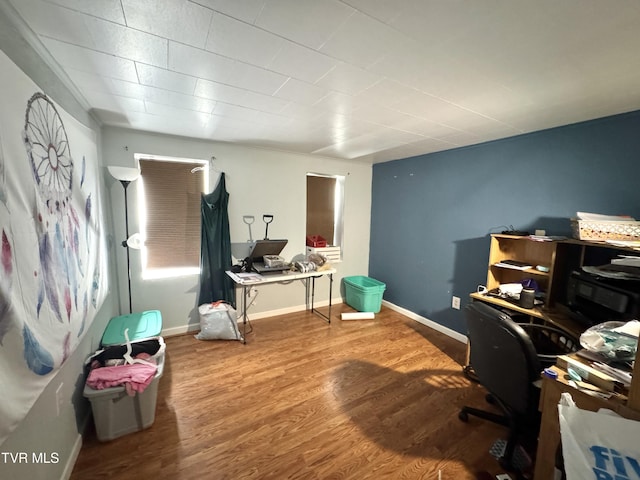 office space featuring baseboards and wood finished floors