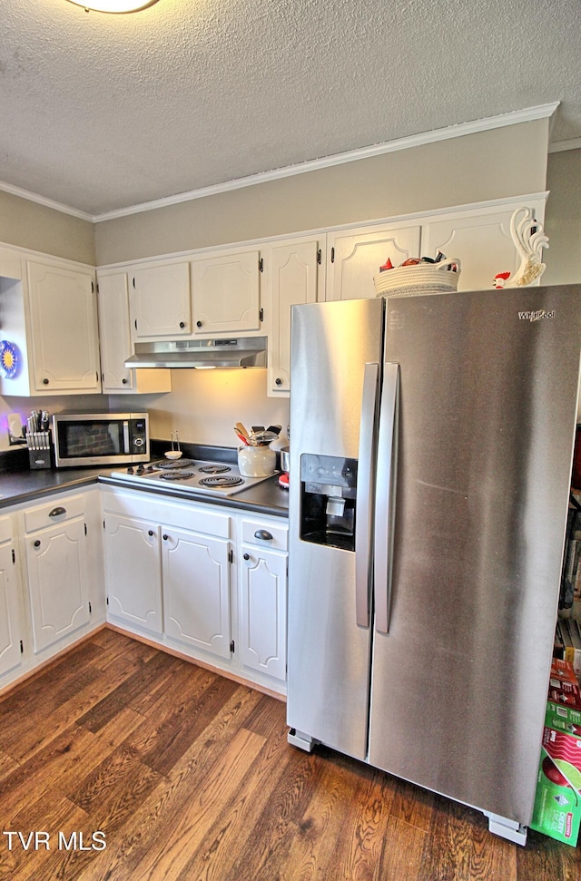 kitchen featuring under cabinet range hood, dark countertops, white cabinetry, appliances with stainless steel finishes, and dark wood-style flooring