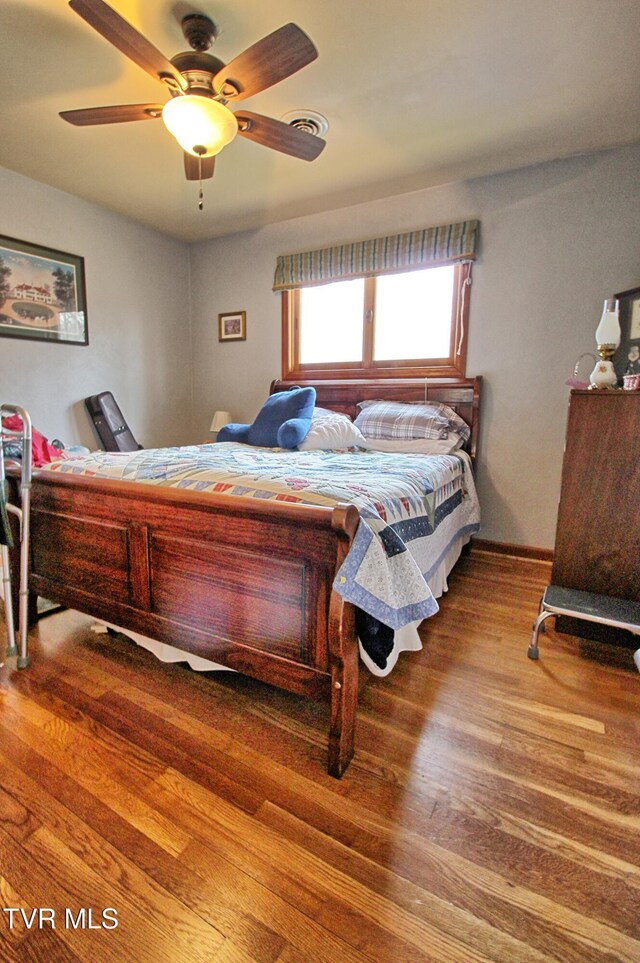 bedroom featuring ceiling fan and wood finished floors