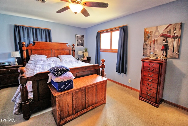 bedroom with light colored carpet, baseboards, and ceiling fan