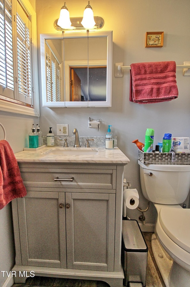 bathroom featuring toilet and vanity