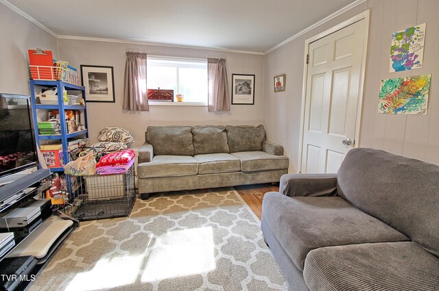 living area with crown molding and wood finished floors