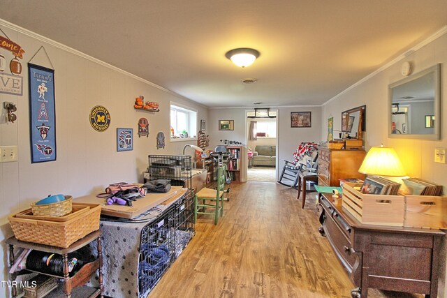 office area featuring wood finished floors and ornamental molding