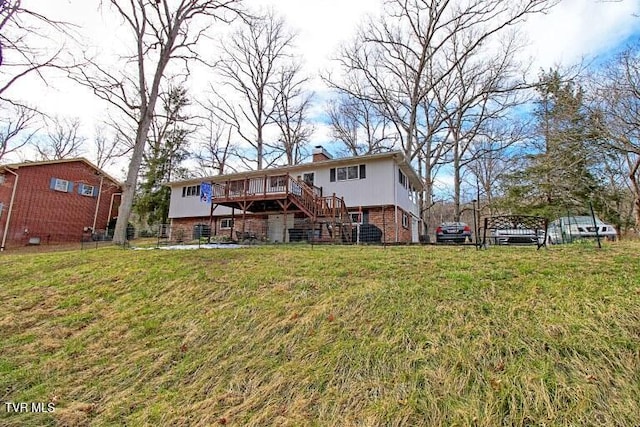 rear view of property with a wooden deck, a yard, a chimney, stairs, and brick siding