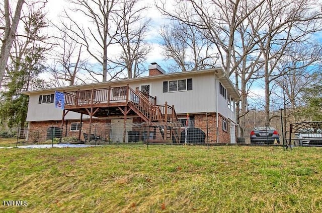 back of house with a wooden deck, a chimney, stairs, a lawn, and brick siding