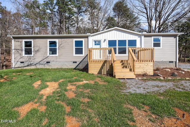 back of property featuring crawl space, a wooden deck, and a yard