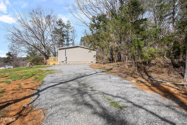 view of home's exterior featuring crawl space and driveway