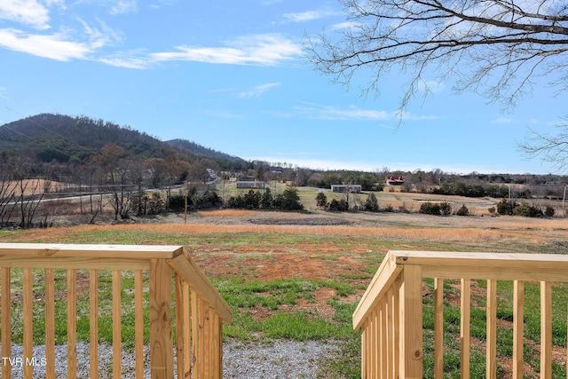 view of yard with a rural view and a mountain view