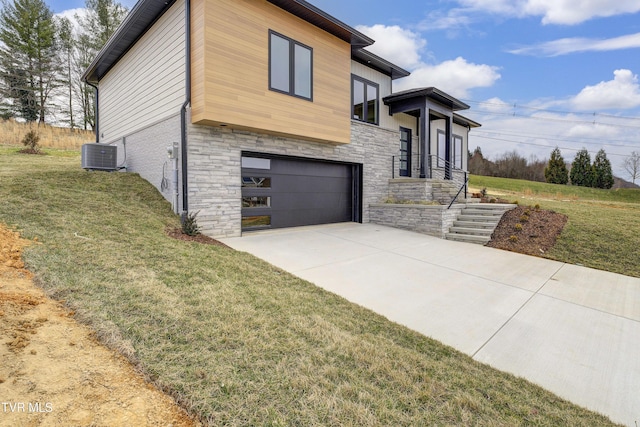 view of property exterior featuring stone siding, a lawn, central AC unit, and driveway