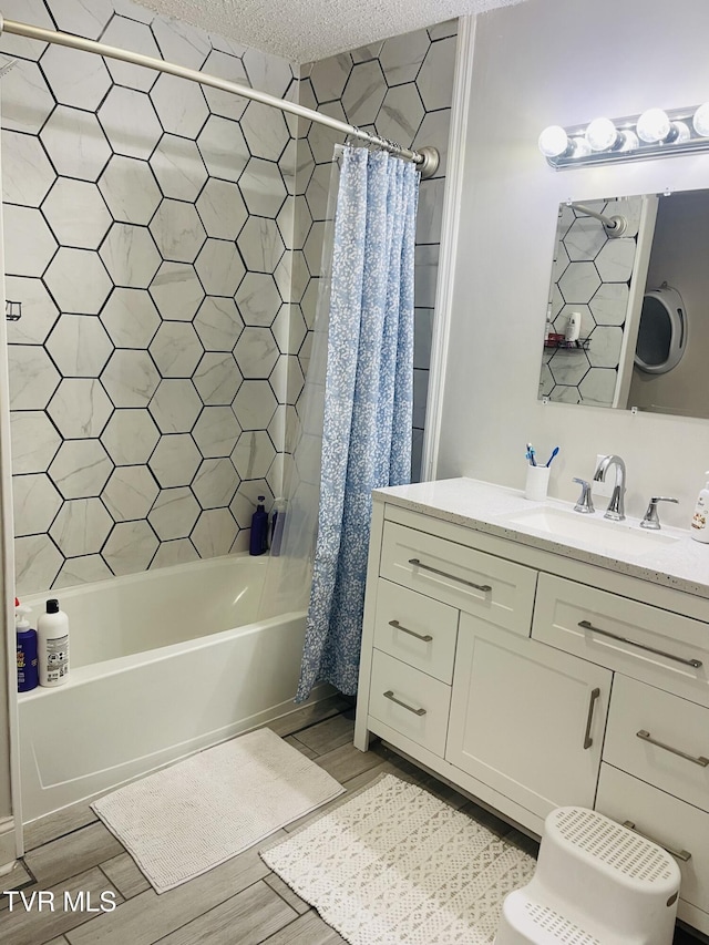 bathroom featuring shower / bath combo with shower curtain, a textured ceiling, wood finished floors, and vanity