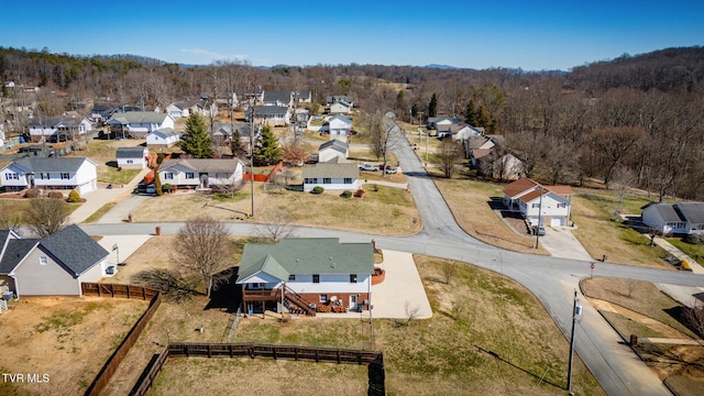 aerial view featuring a residential view and a wooded view