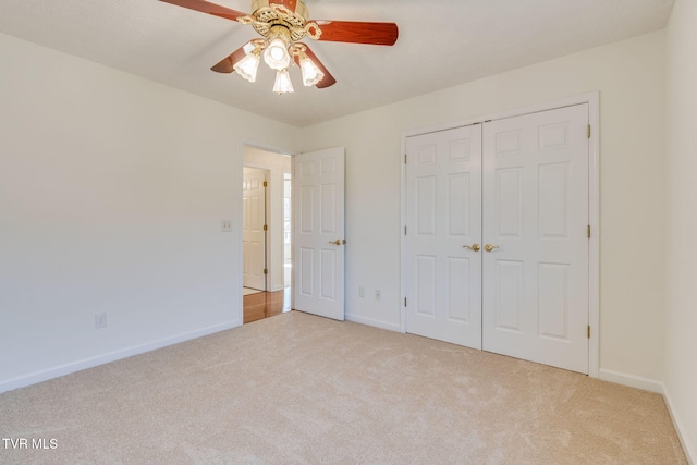 unfurnished bedroom featuring baseboards, carpet floors, a closet, and ceiling fan