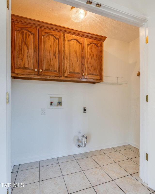 washroom with washer hookup, hookup for a gas dryer, cabinet space, light tile patterned floors, and hookup for an electric dryer