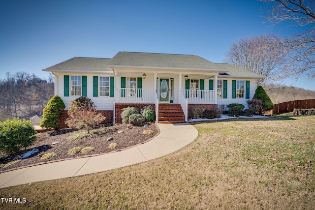 ranch-style house with covered porch and a front lawn