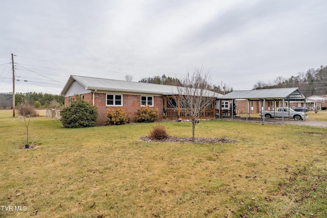 single story home with brick siding, metal roof, and a front yard