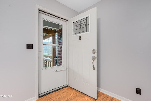 interior space featuring baseboards and light wood-style flooring