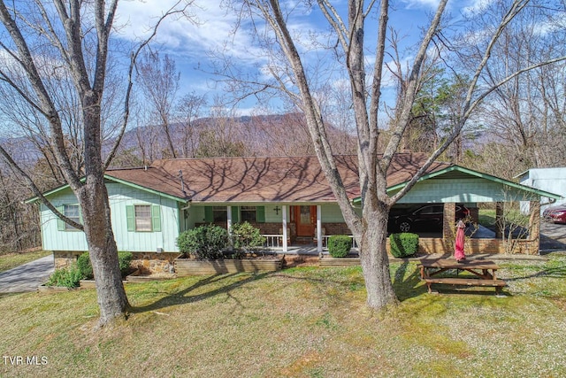 single story home with a front yard, a porch, and board and batten siding