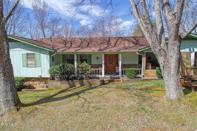 ranch-style home with brick siding and a front yard