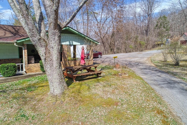 exterior space with brick siding and driveway