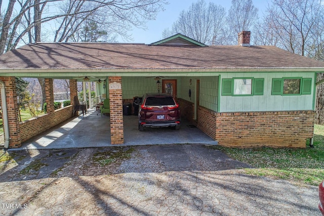 view of parking / parking lot featuring an attached carport and driveway