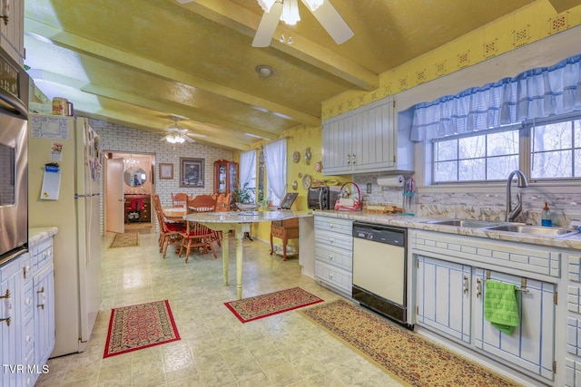 kitchen featuring white appliances, lofted ceiling with beams, ceiling fan, a sink, and light countertops