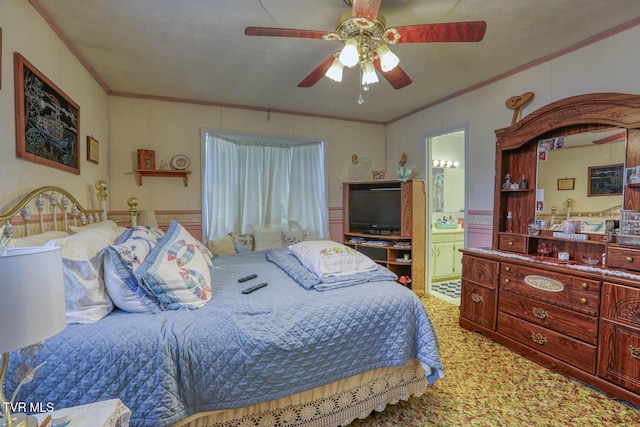 bedroom with light carpet, connected bathroom, a ceiling fan, and ornamental molding