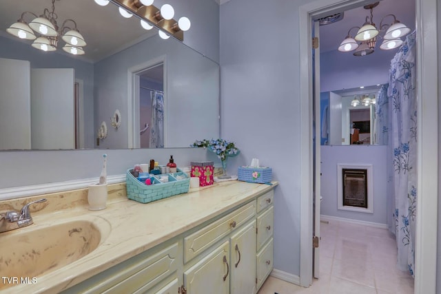 full bathroom with a notable chandelier, a fireplace, vanity, and tile patterned flooring