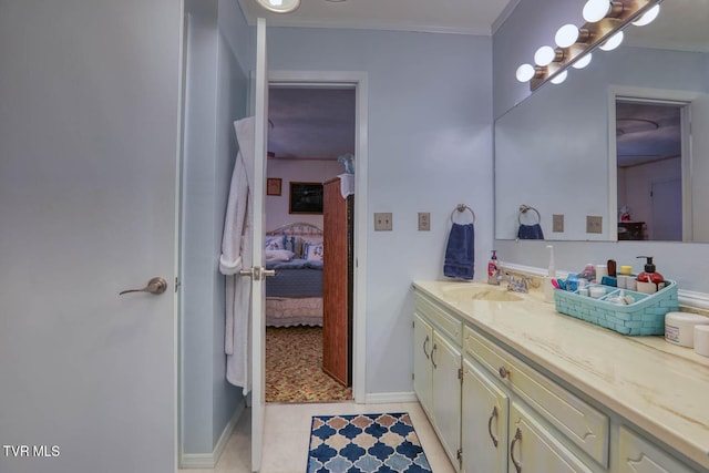 bathroom with connected bathroom, vanity, baseboards, and ornamental molding