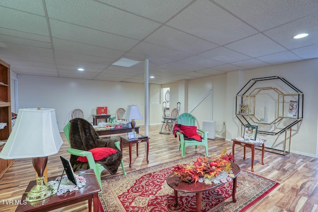 sitting room featuring recessed lighting, a paneled ceiling, baseboards, and wood finished floors