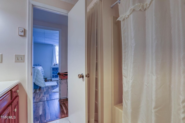 full bath featuring vanity, a shower with curtain, and wood finished floors