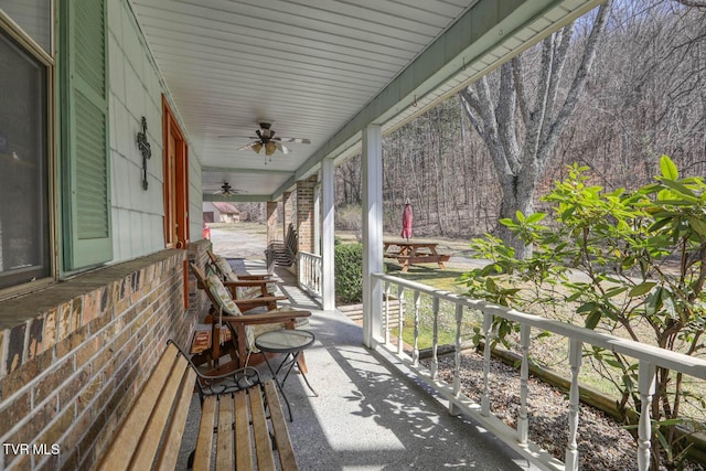 wooden deck with a porch and ceiling fan