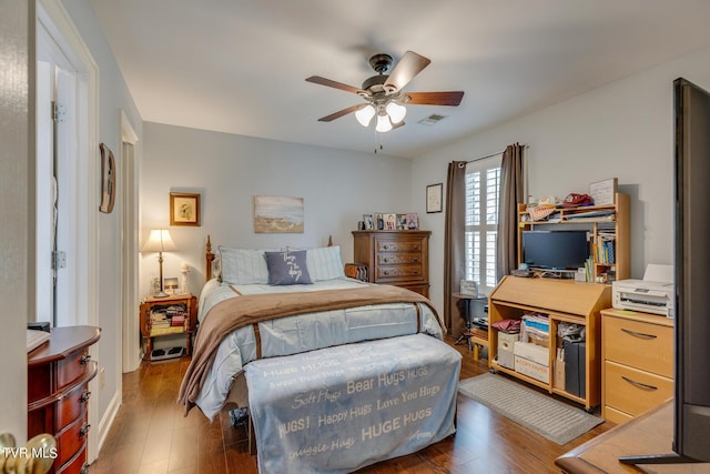 bedroom with visible vents, ceiling fan, and wood finished floors