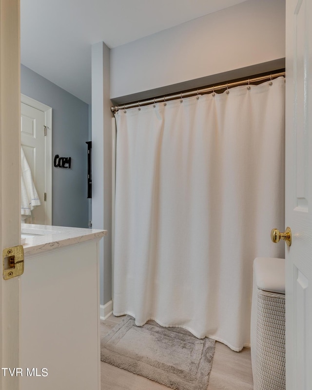 full bath with vanity and wood finished floors