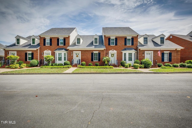 view of front of home featuring brick siding and a residential view