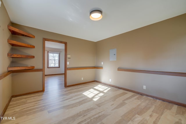 empty room with baseboards and wood finished floors