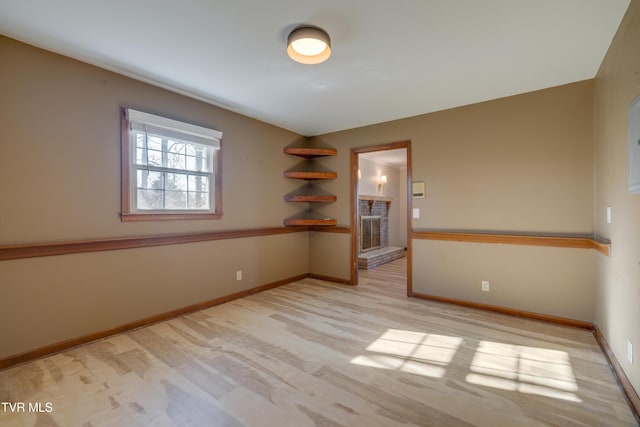 empty room with light wood-style flooring and baseboards