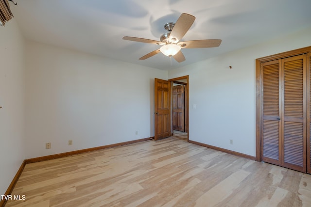 unfurnished bedroom with a closet, light wood-style flooring, and baseboards