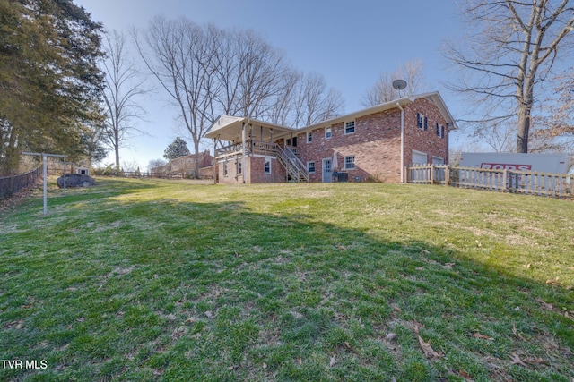 view of yard featuring stairway and fence