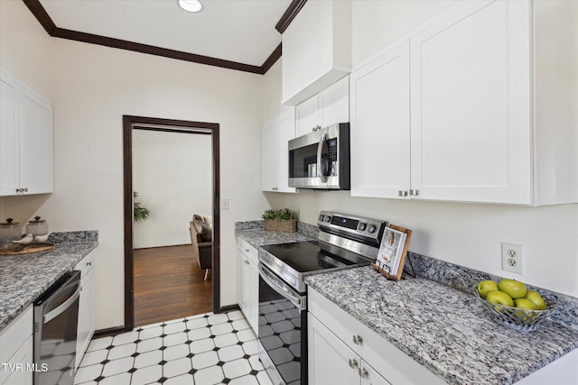 kitchen featuring light floors, appliances with stainless steel finishes, white cabinets, and crown molding