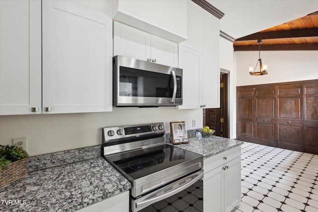 kitchen featuring tile patterned floors, vaulted ceiling with beams, white cabinetry, and stainless steel appliances