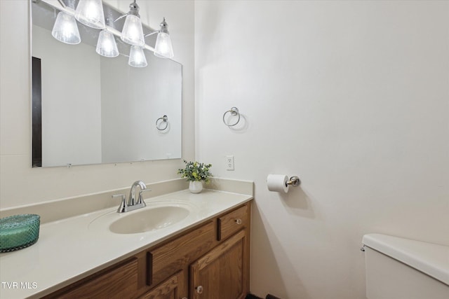 bathroom featuring toilet and vanity