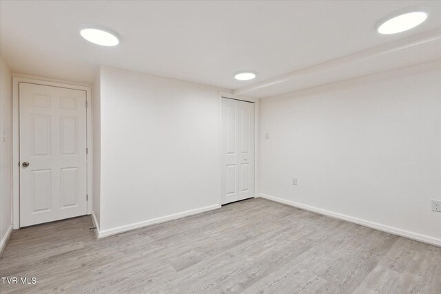 unfurnished room with wood finished floors and baseboards