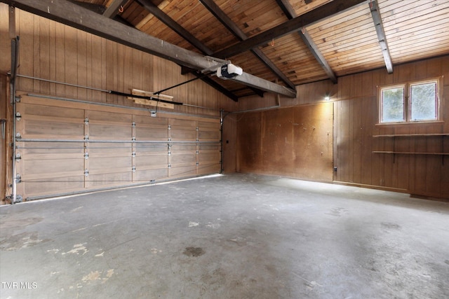 garage with a garage door opener and wood walls