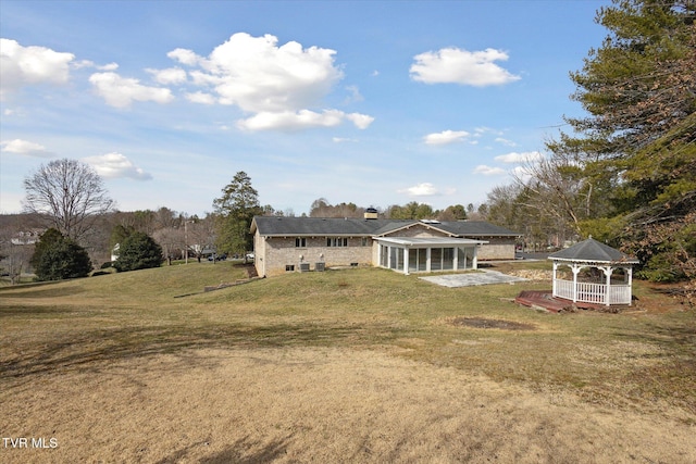 exterior space with a gazebo and a lawn