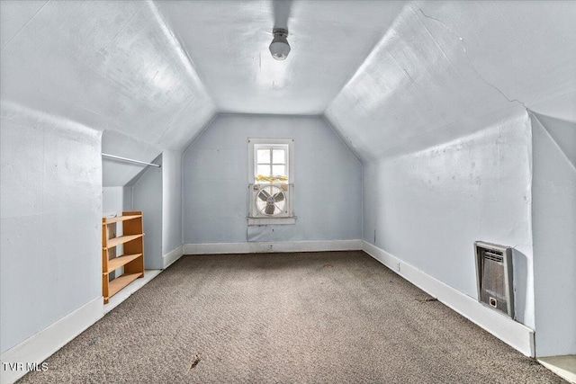 bonus room featuring carpet flooring, vaulted ceiling, heating unit, and baseboards